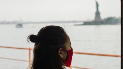 woman in red blazer near the window