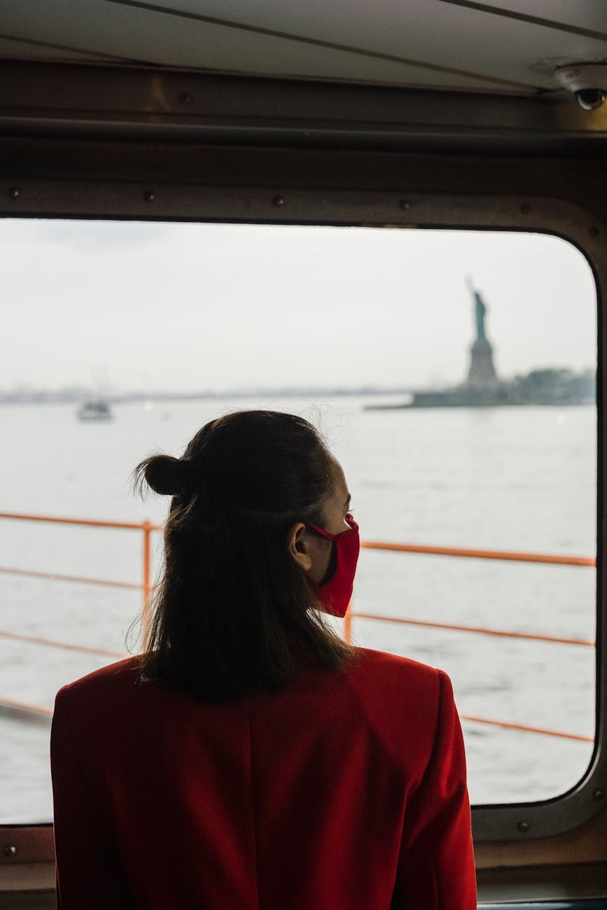 woman in red blazer near the window