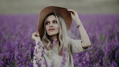 woman sitting in field of violet flowers