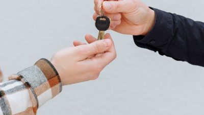 a person handing out a key