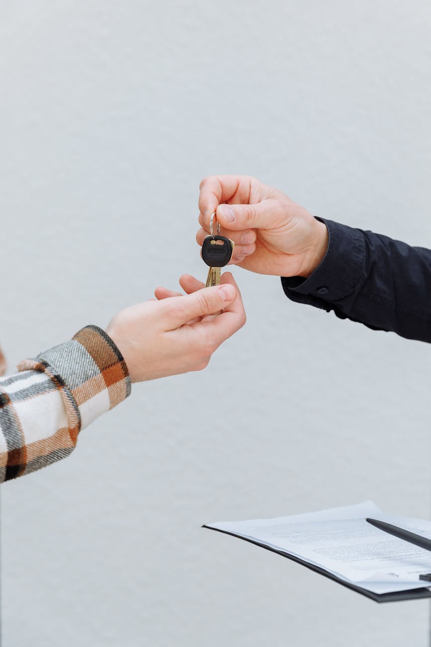 a person handing out a key