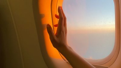 persons hand near airplane window