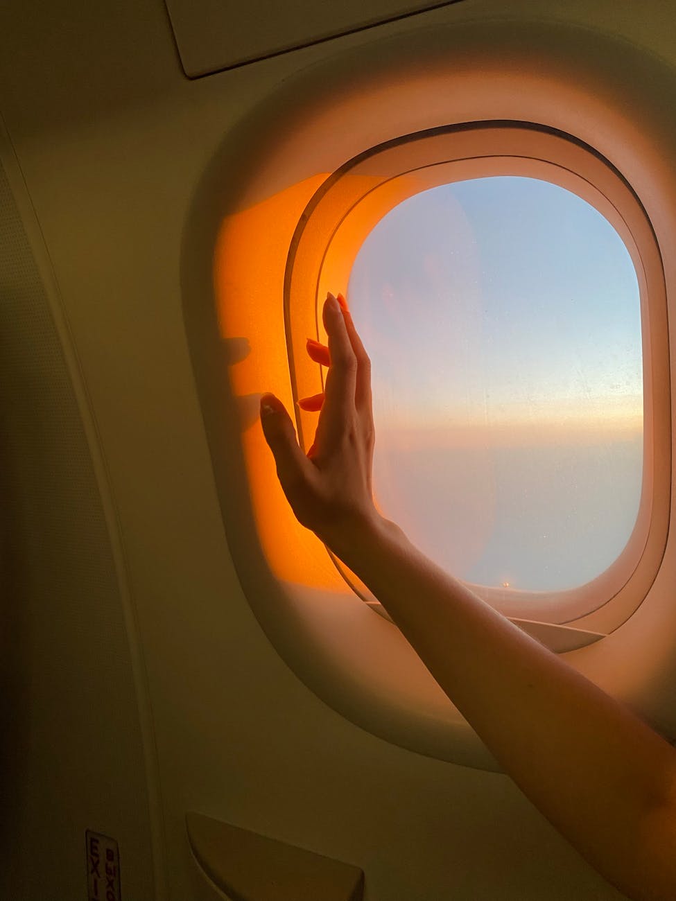 persons hand near airplane window