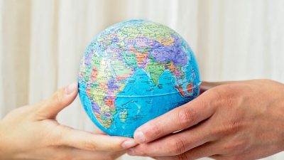 close up shot of a person holding a globe