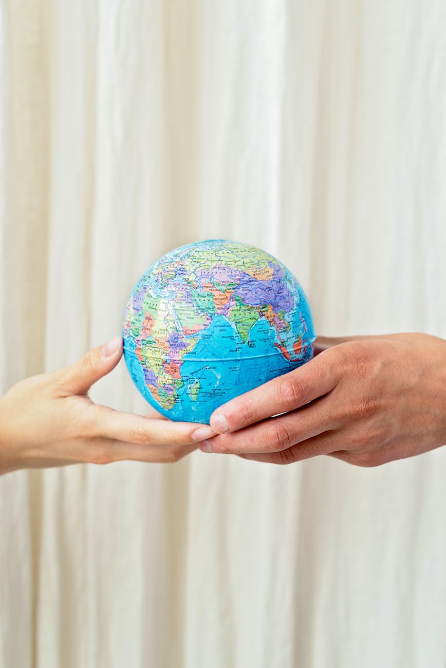 close up shot of a person holding a globe