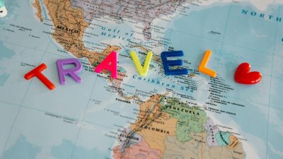 travel letters and heart on map