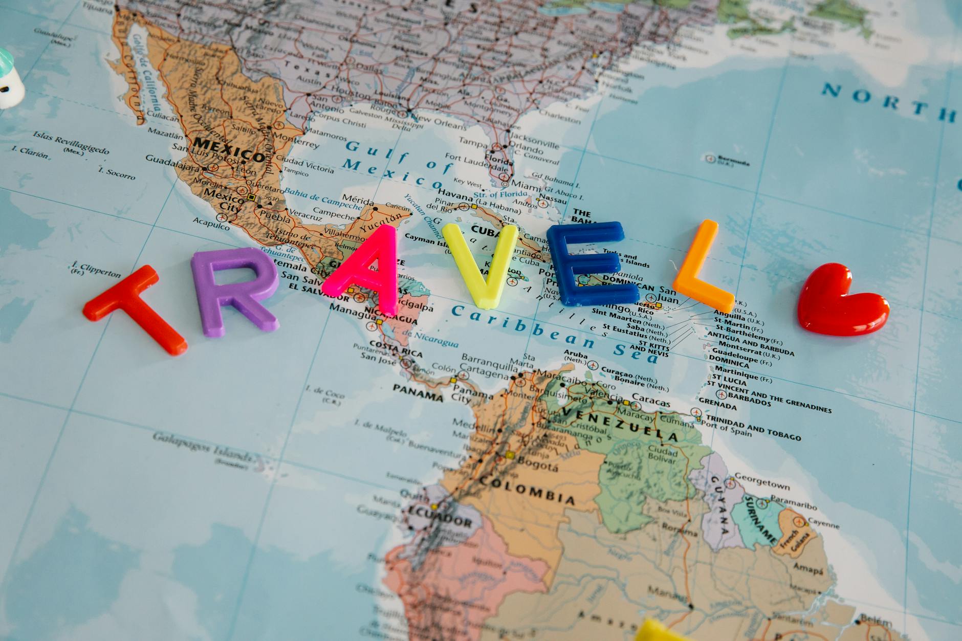 travel letters and heart on map