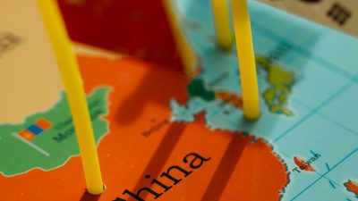 close up shot of world map with flaglets