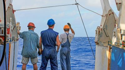 fishermen working on boat at sea