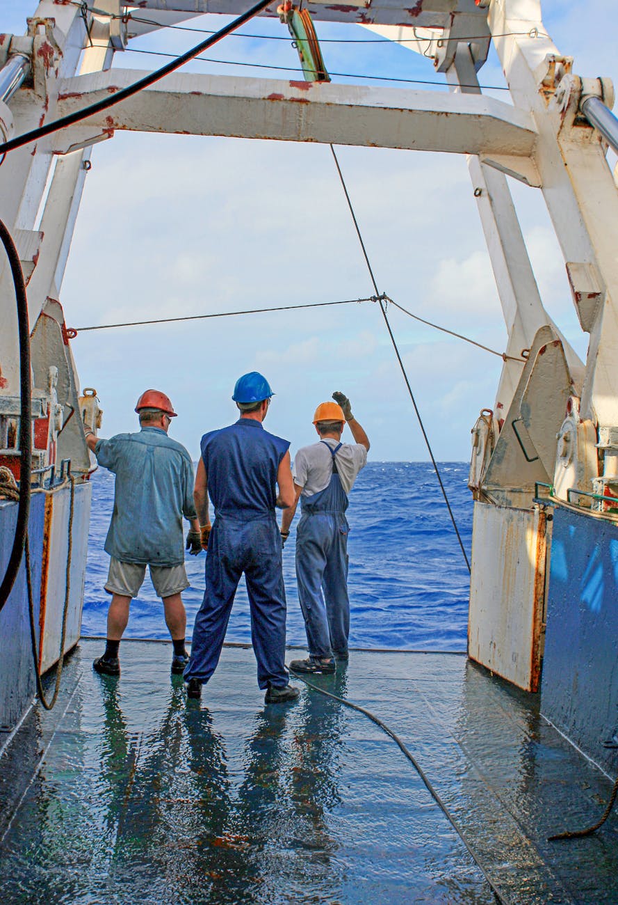 fishermen working on boat at sea