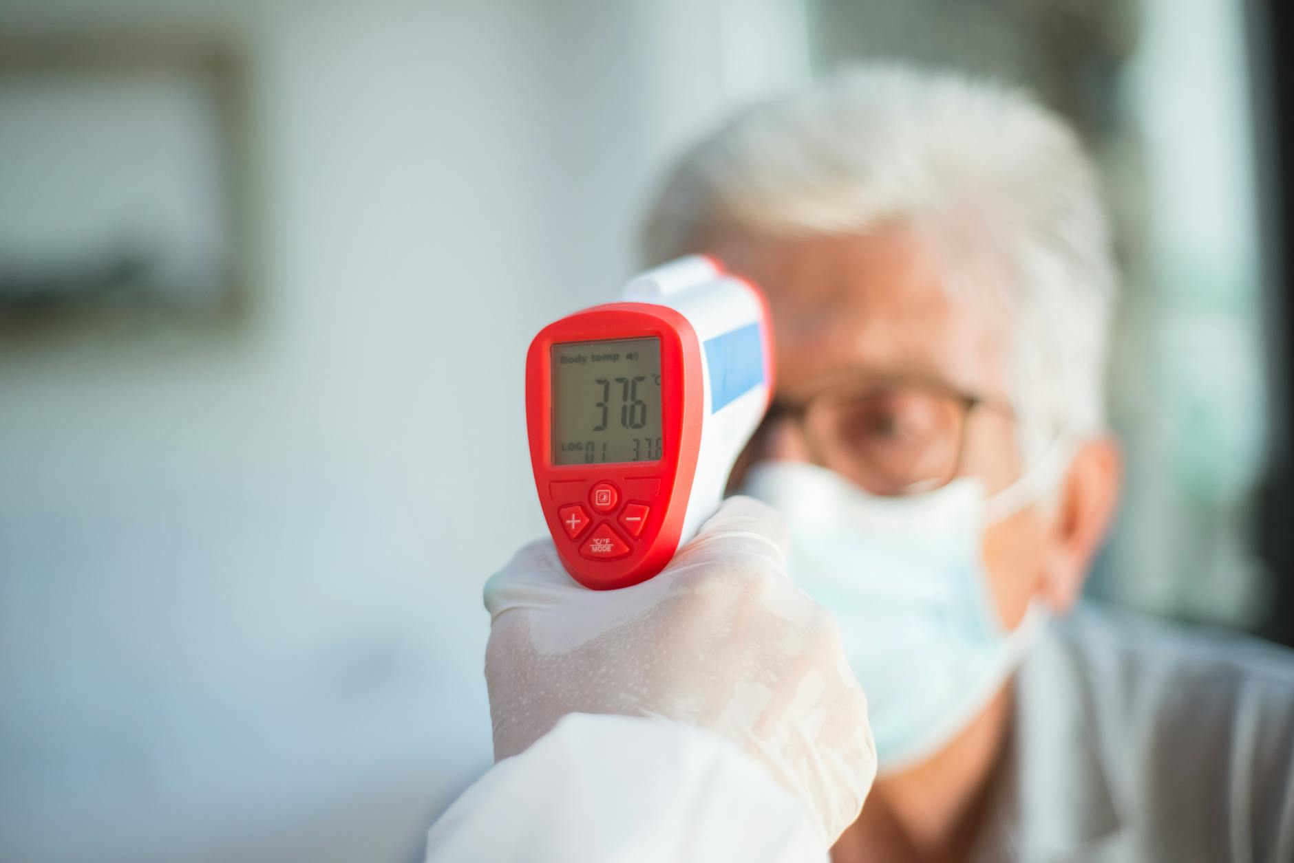 man during thermometer medical exam