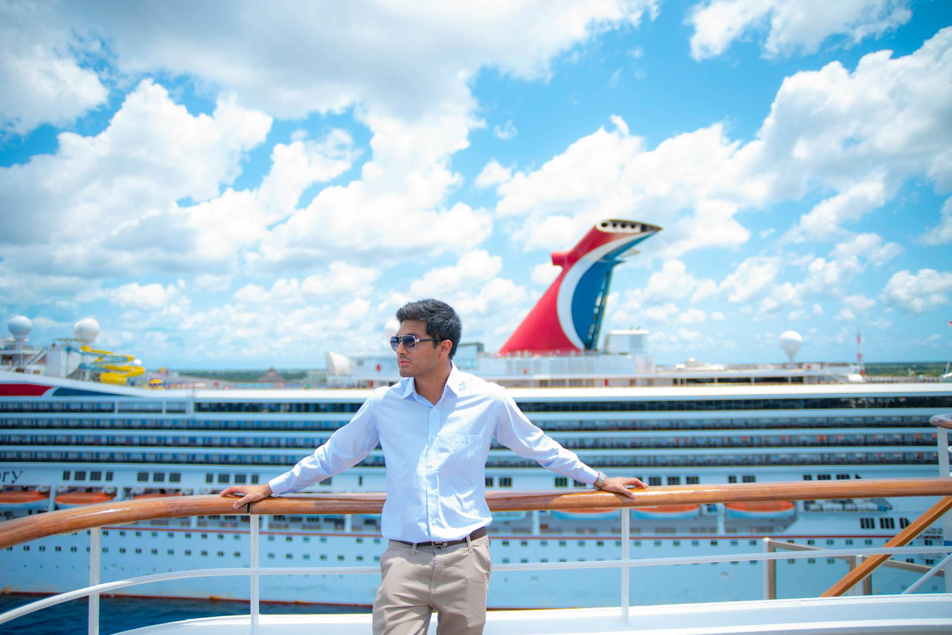 a man in white long sleeves standing on the ship