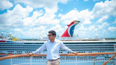a man in white long sleeves standing on the ship