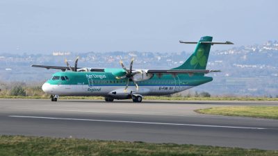 green passenger plane on runway