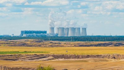 a brown field with industrial plant on the background in munich germany
