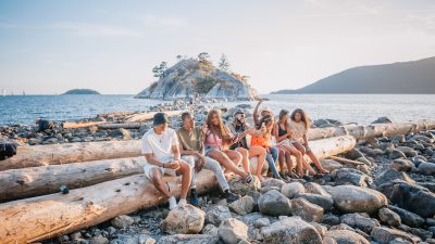 people sitting on long wooden log