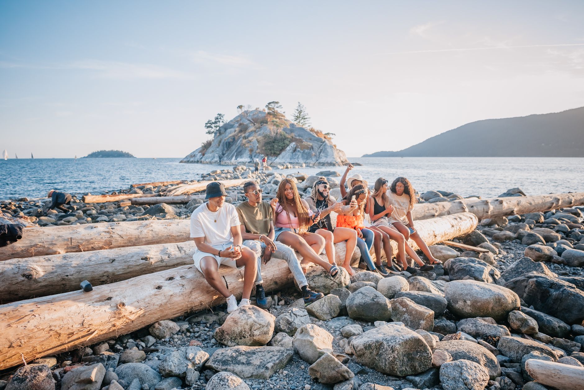 people sitting on long wooden log