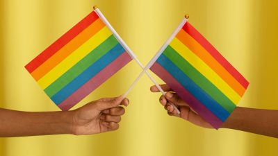 two people holding pride flag