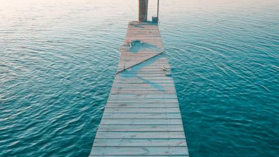 wooden pier on a lake at sunset