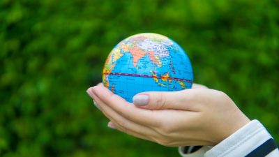 female hands holding a globe