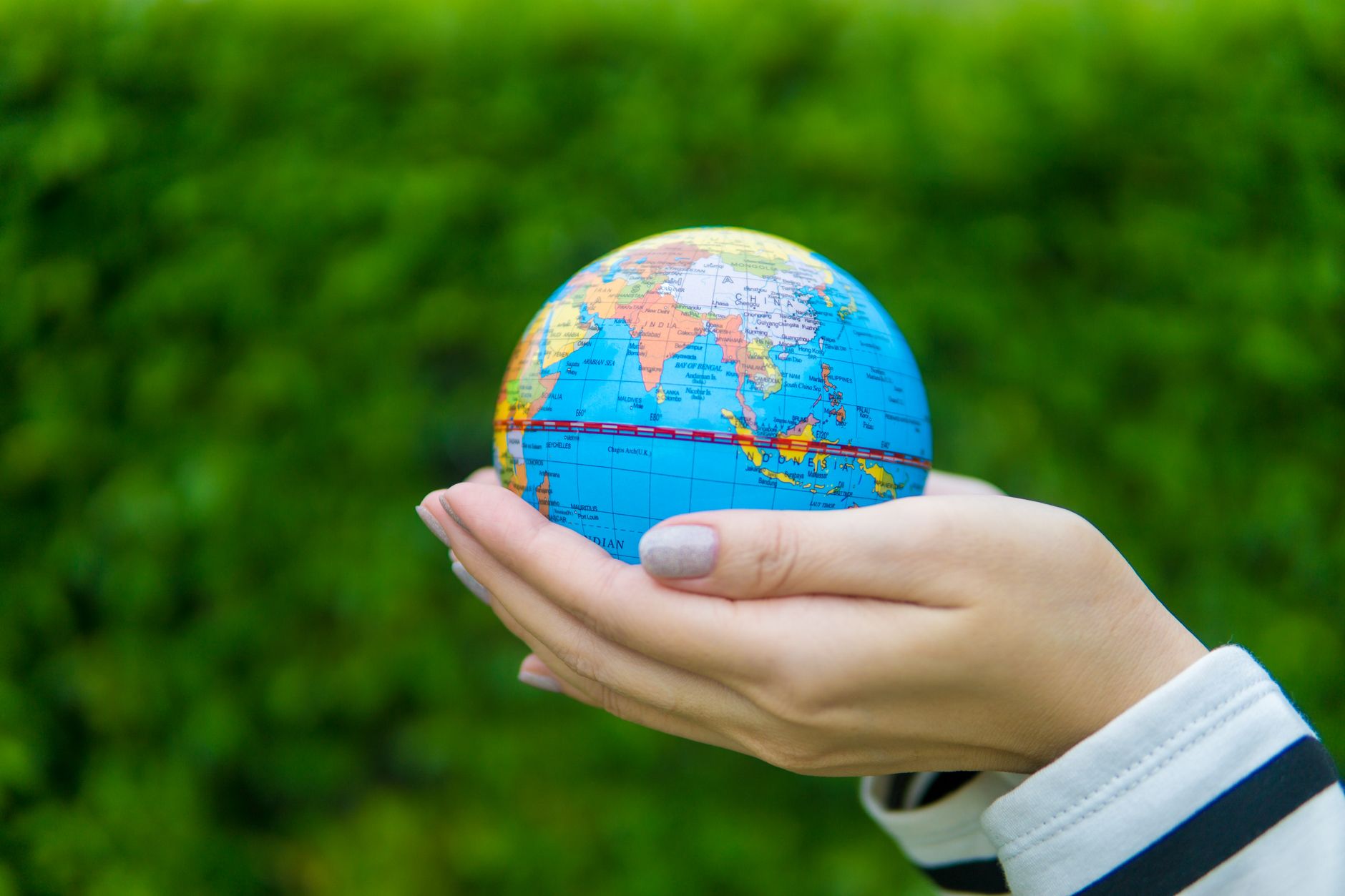 female hands holding a globe