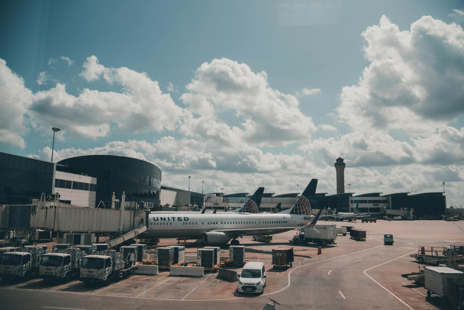 a white airplane parked on airport apron