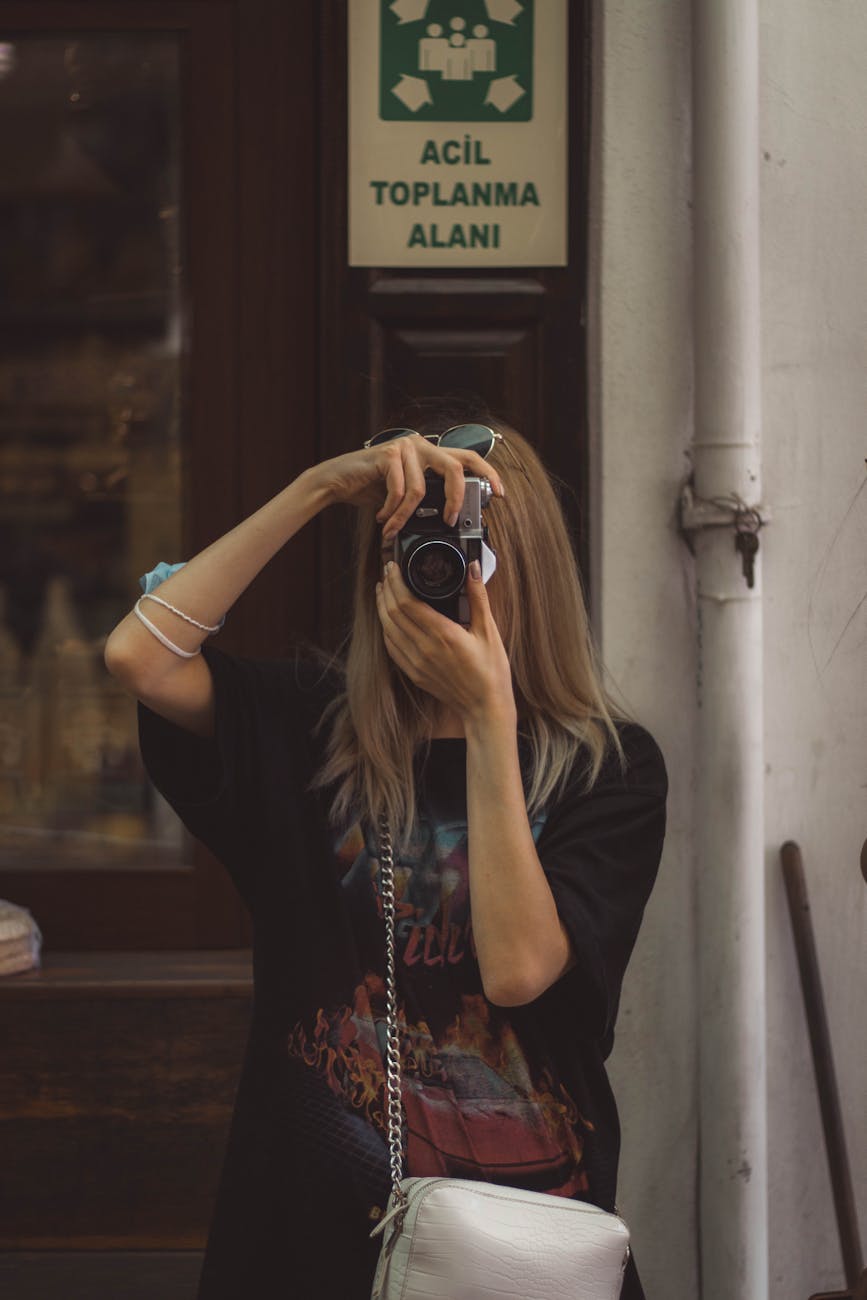 woman taking picture on street